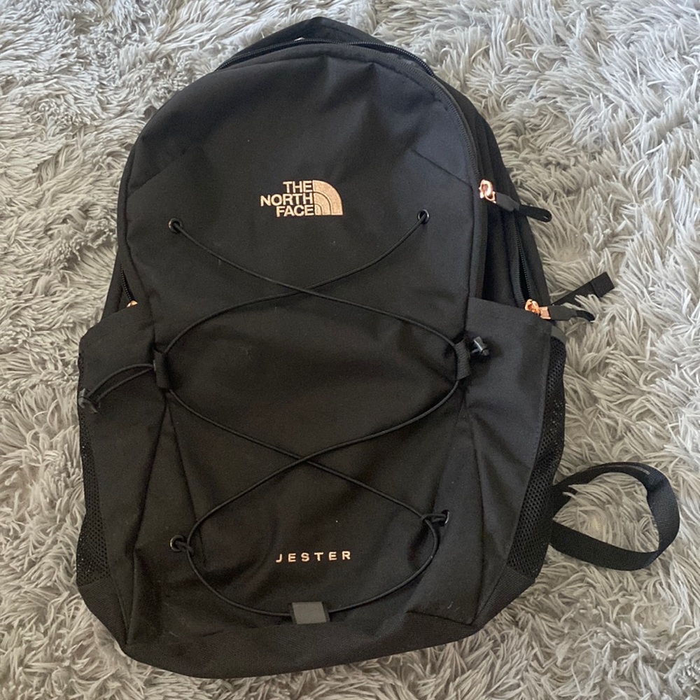 Black north face backpack with rose gold writing